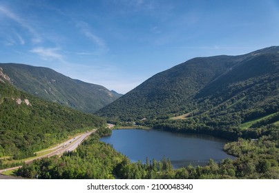 Interstate highway 93 through Franconia notch near echo lake at the base of cannon mountain in the white mountain region of - Shutterstock ID 2100048340