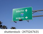 Interstate highway I-5 Southbound and Northbound directional signage isolated against a blue sky background.