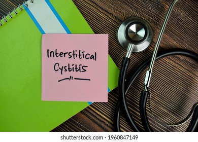 Interstitical Cystitis write on sticky notes isolated on Wooden Table.