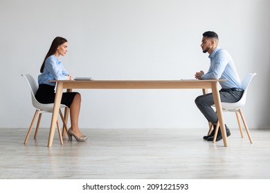 Interview, Business Meeting Concept. Profile Side View Of Two Serious People In Formalwear Sitting In Front Of Each Other At Long Desk In The Office While Discussing Something, Hr Hiring Staff