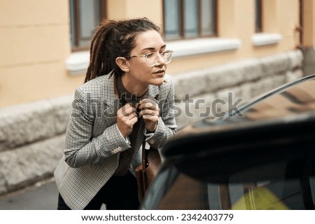 Interview, business and a woman getting ready in the city with a reflection in the car window. Hiring, recruitment and job opportunity with a female vacancy candidate checking her appearance for hr