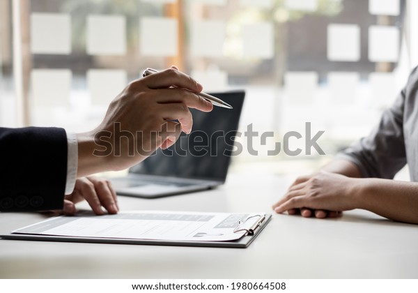 Interview employee talking about resume and job\
description with job applicants sitting in front in the office, Job\
applications\
concepts.