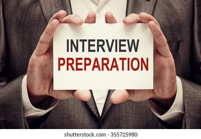 Interview Preparation. Businessman holding a card with a message text written on it