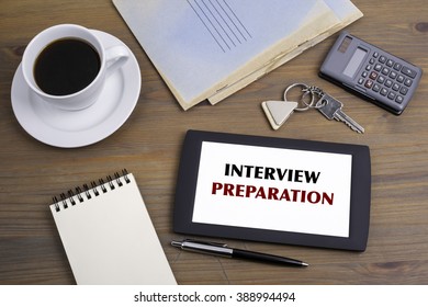 Interview Preparation. Text on tablet device on a wooden table