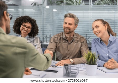 The interview process takes place in the office. It includes a meeting with the HR department and a screening of candidates for the vacancy. A handshake with the candidate.