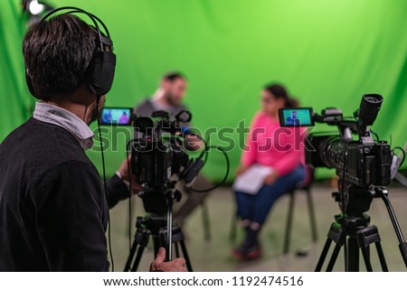 Interview recorded in a chroma with two cameras and one cameraman in frame