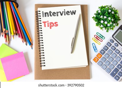interview tips text message on white paper and office supplies, pen, paper note, on white desk , copy space / business concept / view from above, top view