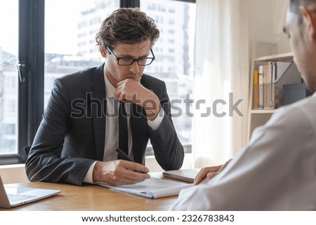 interviewer on the table asking question applicant in the office.