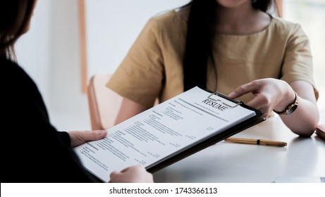 Interviewer reading a resume, Person submits job application, Person describe yourself to interviewer, focus on resume, recruiter considering application, hr manager making hiring decision - Shutterstock ID 1743366113