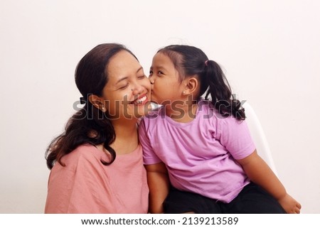 The intimacy of a asian mother with her daughter. Mothers day concept.