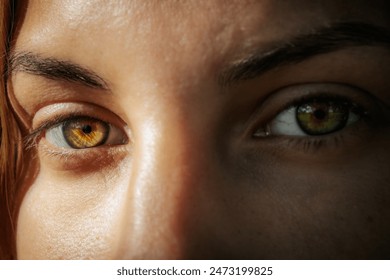 Intimate close-up of a womans face highlighting her striking green eyes and natural complexion, with a serene expression and natural background. - Powered by Shutterstock