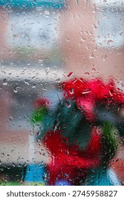 Intimate Scene Featuring Ruby Flowers Pressed Against Rainsoaked Glass With Atmospheric City Background