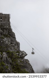 Into the Clouds: Cable Car Ascending Table Mountain in the Mist