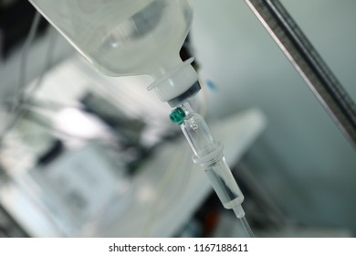 Intravenous Drip System Hanging On The Iron Tripod In The Hospital Room.