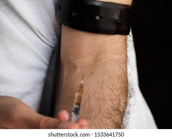 Intravenous Drug Use. An Addict Gives A Shot Of Heroin Or A Similar Drug. Imitation