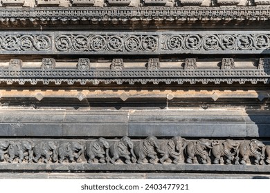 Intricate carvings of a line of elephants on the wall of the ancient Chennakashava temple in Belur in Karnataka. - Powered by Shutterstock