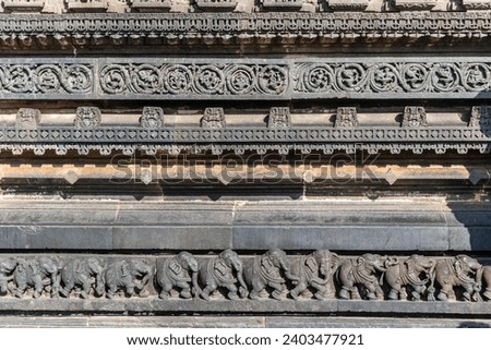 Intricate carvings of a line of elephants on the wall of the ancient Chennakashava temple in Belur in Karnataka.