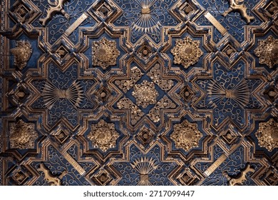 Intricate ceiling design with geometric patterns and ornate details in gold and blue tones