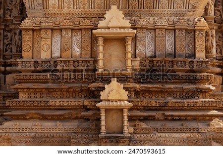 Intricate designs and the missing sculpture in the frames on the wall of Kandariya Mahadeva Temple in the Khajuraho temple complex, India