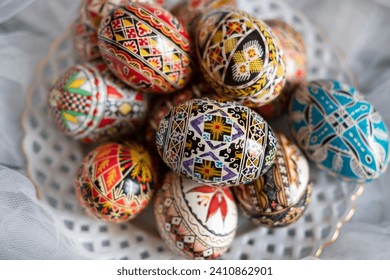 Intricate Easter eggs, part of the Northern Romanian custom of wax coloring and painting elaborate traditional symbols and motifs on the eggshell with a special tool, a drawing pen known as "chisita" - Powered by Shutterstock