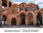 The intricate facade of Saint Demetrius Church (Mitropolis of Mystras), featuring stunning Byzantine architecture and historic arches.