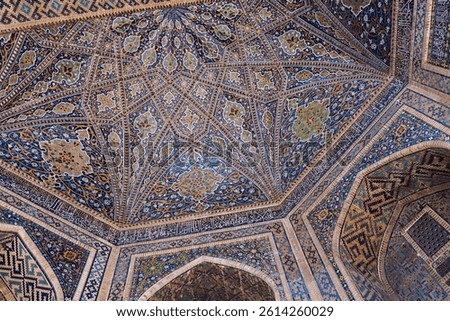 Intricate geometric tilework decorates the ceiling of a historic Tilya-Kori Madrasah. Samarkand, Uzbekistan. Islamic Architcture