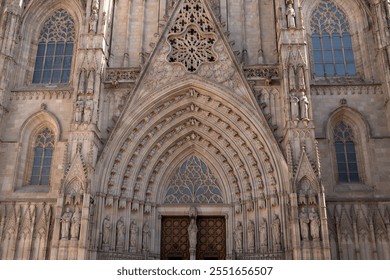 Intricate Gothic architecture of a historic cathedral in Barcelona showing detailed stone carvings and towering spires - Powered by Shutterstock