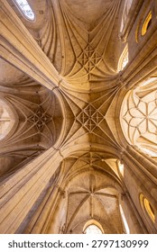 Intricate Gothic vaulting creating patterns on the historic cathedral ceiling in Spain