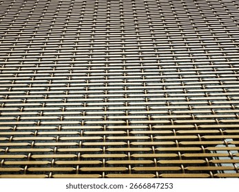 Intricate Metallic Grid Pattern Showcasing Texture and Reflection in Modern Architecture  