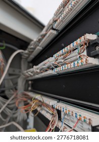 Intricate network patch panel with numerous colorful wiring connections highlighting data infrastructure.