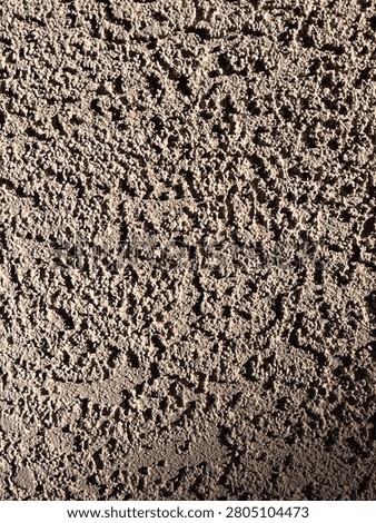 An intricate, non-uniform organic pattern composed of thousands of tiny, irregular aggregate bumps and crevices. The surface variation provides an excellent sense of depth, grit, and structural dimensionality