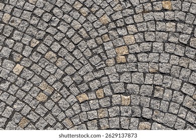 Intricate pattern of stone cobblestone pavement with circular design.