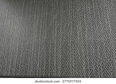 An intricate pattern of stylized branches against a dark gray background creates a compelling visual texture. This abstract design offers a unique and artistic aesthetic.