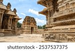 Intricate Stone carvings and architecture of of the vittala temple complex in Hampi India. The temple dedicated to lord vishnu, is renowned for its iconic stone chariot and ornate pillars.