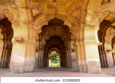 Intricate stone carvings on the arched hallway of the Lotus Mahal Palace in Hampi, Karnataka, India. It is an ancient stone palace structure with tranquil gardens, arches & elaborate carvings. - Powered by Shutterstock