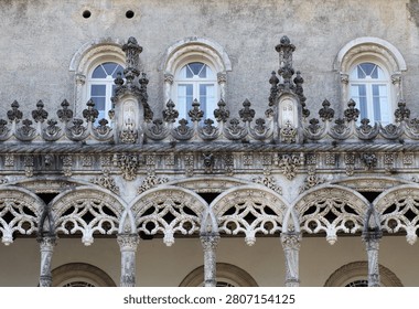 Intricate stonework and windows highlight the unique architecture of Bussaco Palace in Portugal during daylight