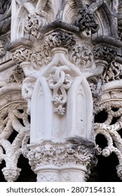 Intricate stonework and windows highlight the unique architecture of Bussaco Palace in Portugal during daylight