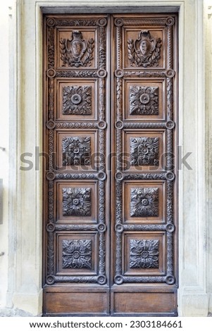 Intricate wooden door at the entrance of Florence Duomo, a captivating blend of craftsmanship and architectural beauty