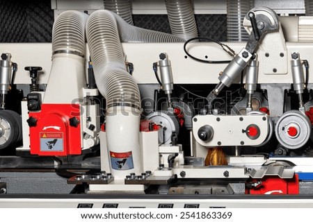 Intricate woodworking machinery operates efficiently, showcasing advanced technology in a busy workshop. The equipment reflects craftsmanship and innovation, vital for modern woodwork.
