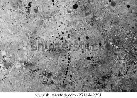 An intriguing composition of black ink splatters on a light background draws attention.