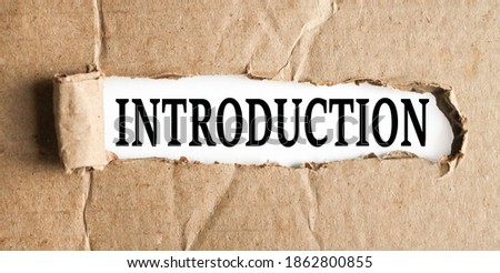 INTRODUCTION, text on white paper on torn paper background
