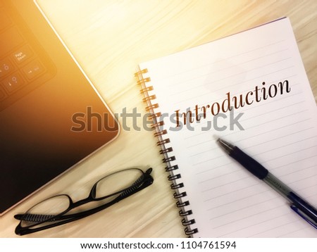 Introduction words on notepad. Business concept with toned image