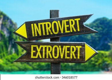 Introvert - Extrovert signpost in a beach background