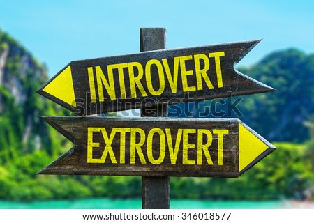 Introvert - Extrovert signpost in a beach background