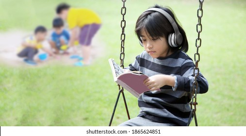 Introvert Mindset Of Asian Kids Happy With Music In Earphone And Stay Alone In Park