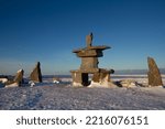 Inukshuk or Inuksuk found near Churchill, Manitoba with snow on the ground in early November, Canada.