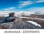 Inukshuk overlooking arctic landscape, Nunavut, Canada.