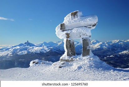Inukshuk at the summit of Whistler Mountain peak on a sunny winter's day
