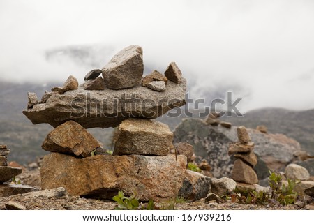 inukshuk in yukon by misty mountains