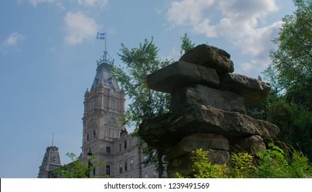 An Inukshuk/stone Sculpture In Front Of A Building In Quebec, Canada